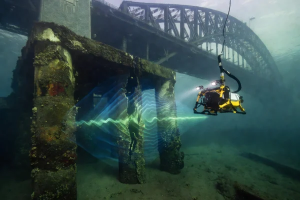 ROV drone capturing sonar data on submerged bridge pilings in Sydney Harbour for structural reinforcement planning